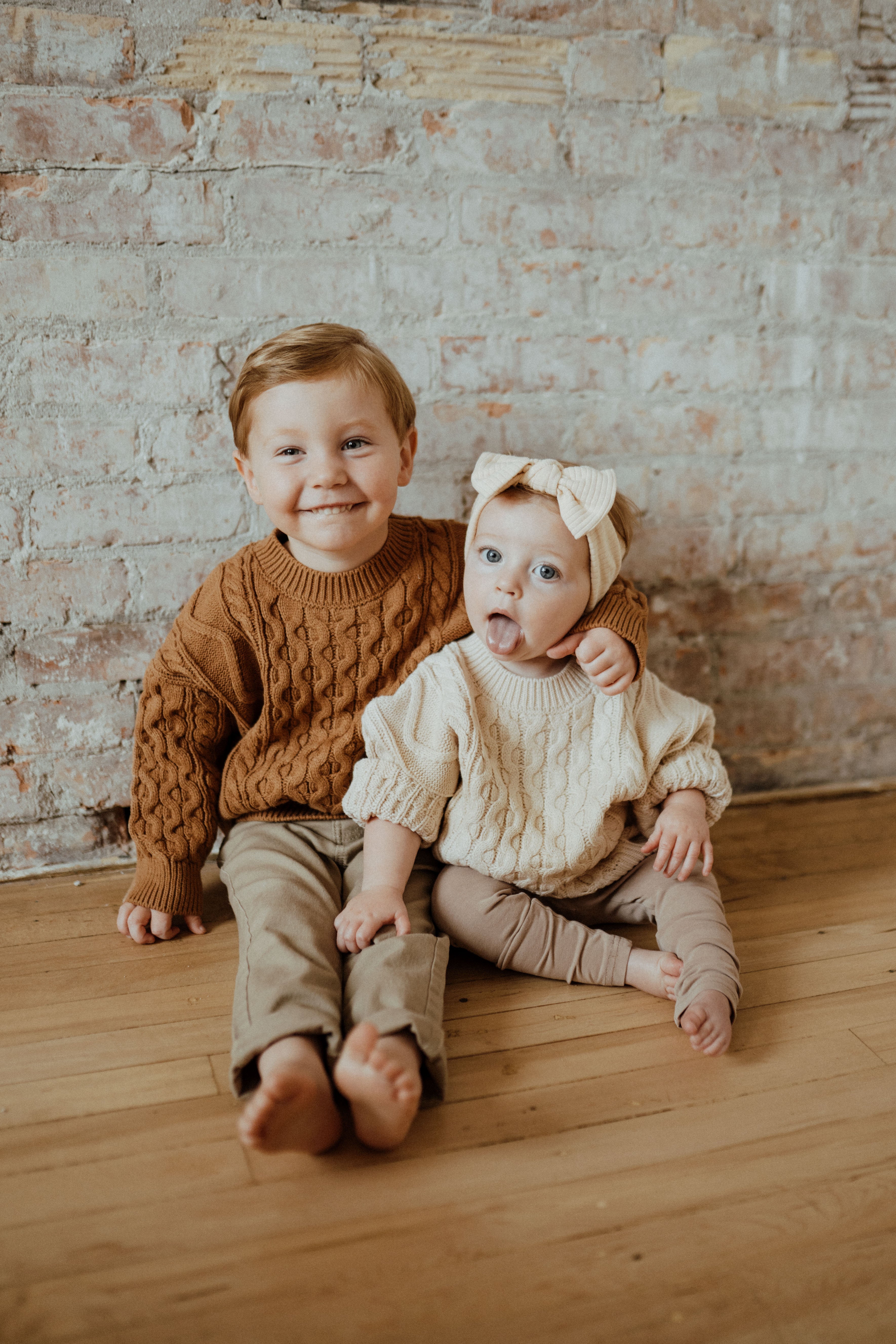 Classic cable knit sweaters in Almond, Cider, and Olive. Sizes 12-18M to 4T. Designed in Canada by ba.be.O, timeless layering pieces for cozy days.